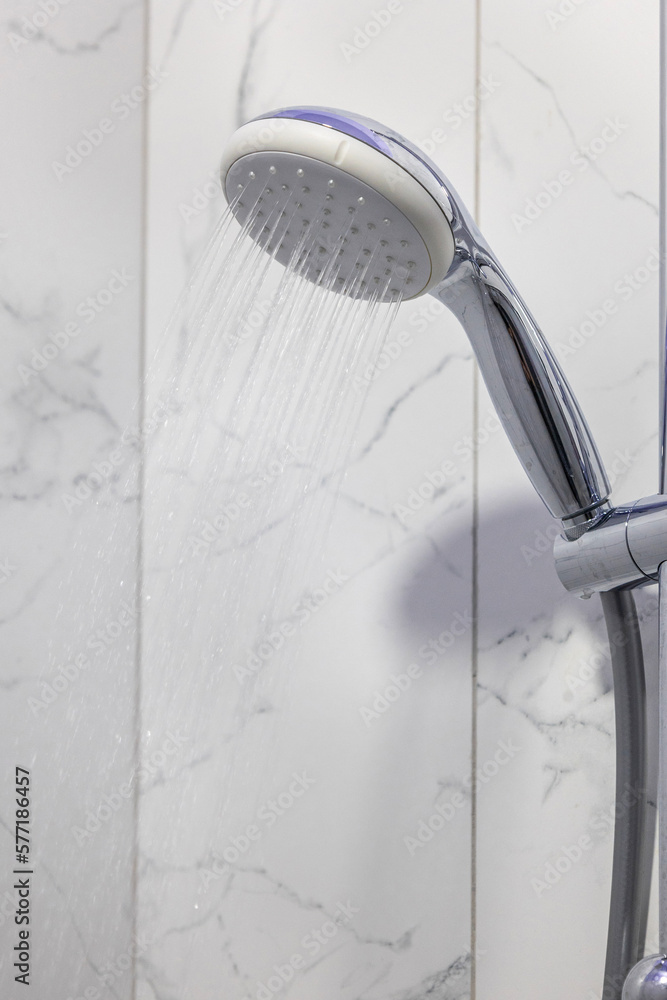 Stream of water splashing out of shower in modern bathroom. Jets of