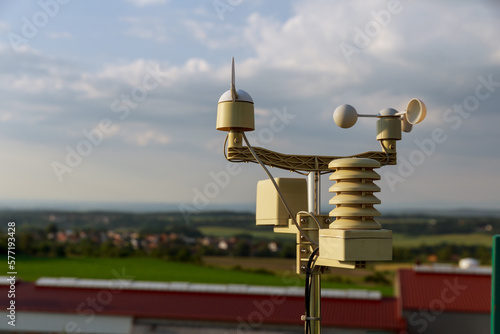 Meterological weather station wind meter anemometer on sky background.