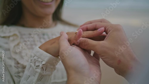 Man hand wearing wedding ring at woman. Unknown lovers celebrating engagement