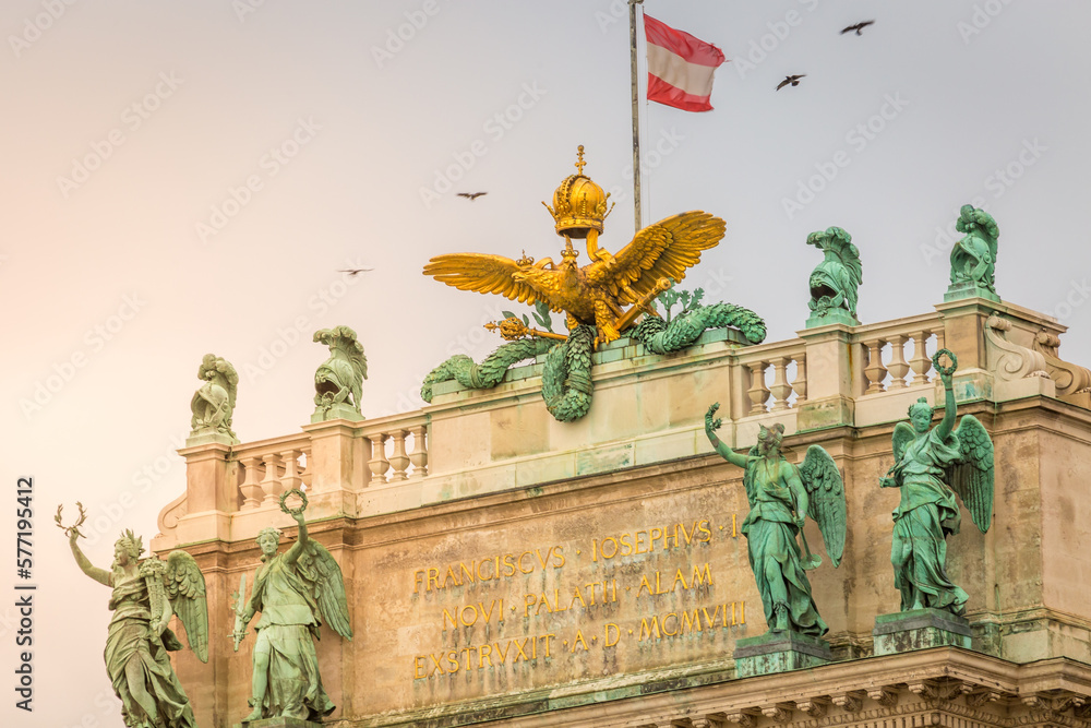 Hofburg palace in Vienna old town with Ausrian flag and doves flying, Austria