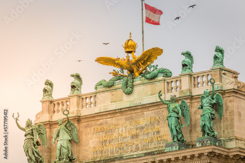 Obraz na płótnie Hofburg palace in Vienna old town with Ausrian flag and doves flying, Austria w salonie