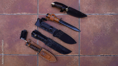 five military men, knives lie on the floor  