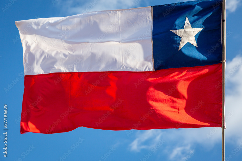Chile National Flag Waving on pole against sunny blue sky background