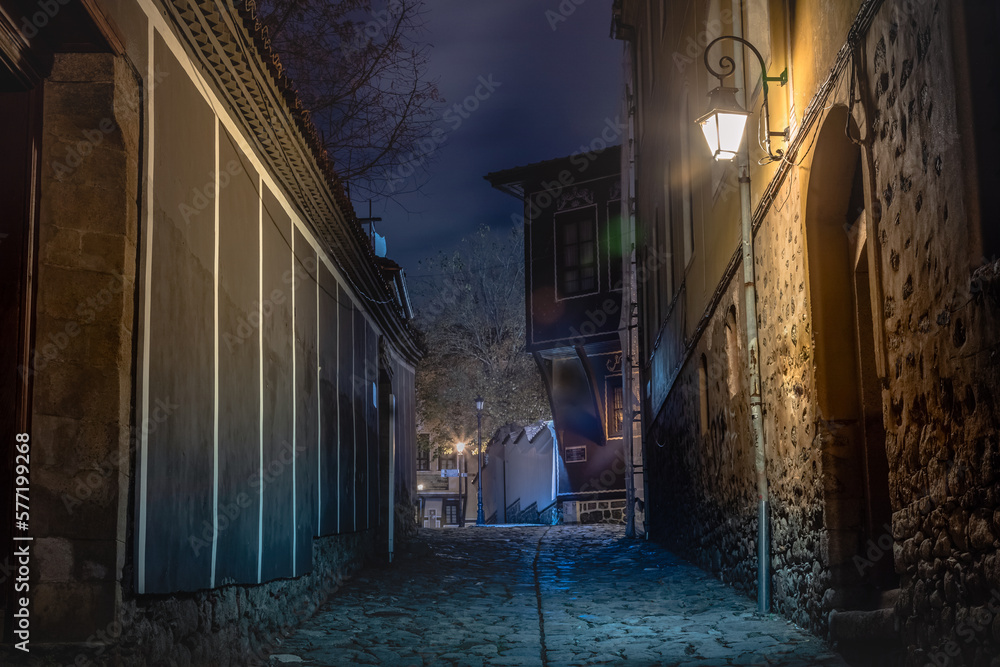 Dark and mysterious alley illuminated at night in Plovdiv, Bulgaria