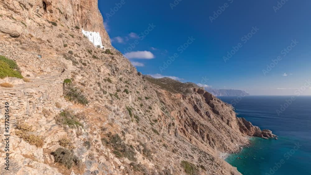 Panorama showing the famous Hozoviotissa Monastery standing on a rock over the Aegean sea in Amorgos island timelapse hyperlapse, Cyclades, Greece. Panorama showing the famous Hozoviotissa Monastery standing on a rock over the Aegean sea in Amorgos island timelapse hyperlapse, Cyclades, Greece.