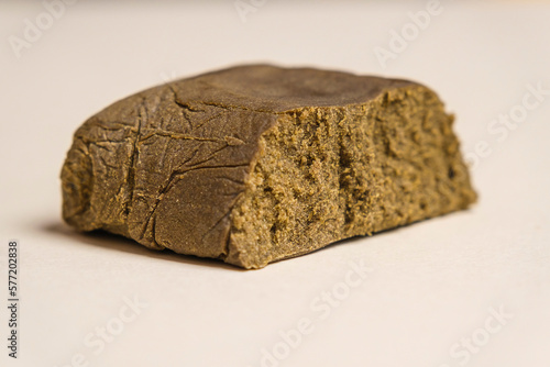 Critical Purple Kush dry base hash. Medical marijuana extraction super dry hashish high quality cannabis pollen on a white background.