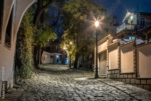 Dark and mysterious alley illuminated at night in Plovdiv, Bulgaria