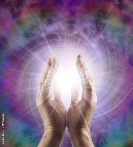 Fototapeta Reiki Master Healer sensing awesome vortexing energy field - male cupped hands r