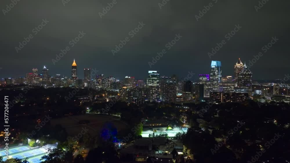 View from above of brightly illuminated high skyscraper buildings in downtown district of Atlanta city in Georgia, USA. American megapolis with business financial district at night