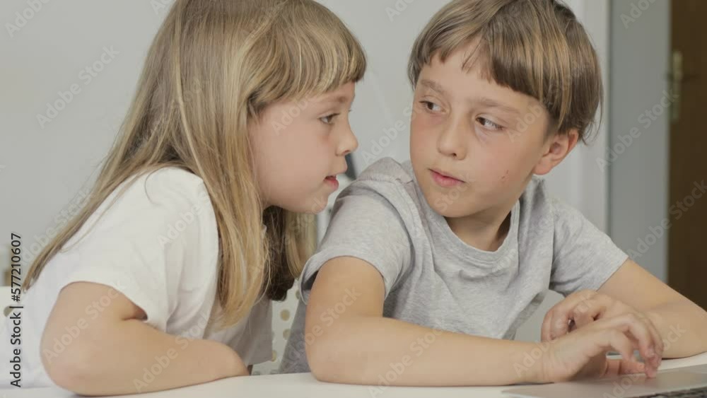 Brother helps his younger sister to make her homework. Brother helps his younger sister to make her homework.