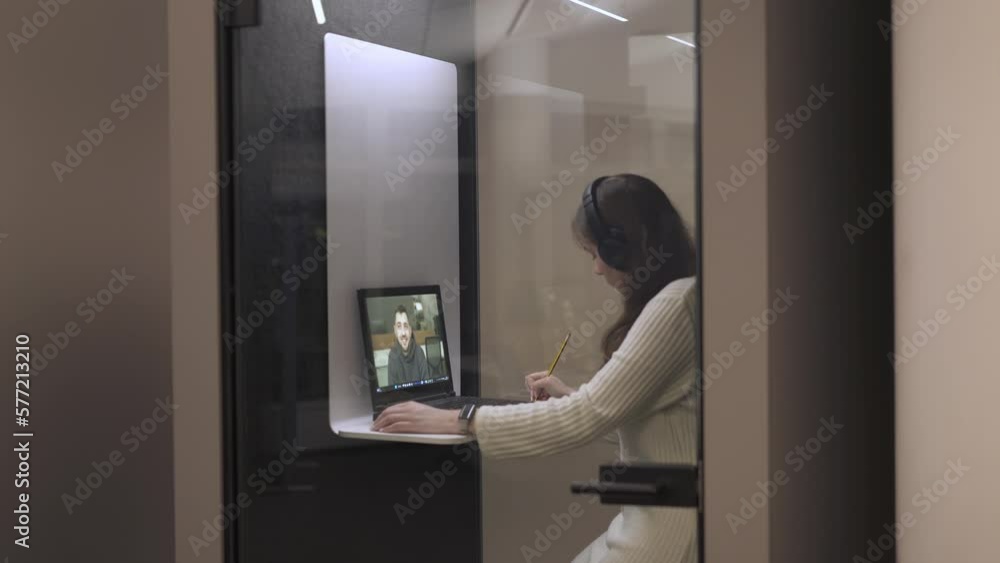 the girl participates in a business meeting in the meeting room, makes notes, talks with the teacher the girl participates in a business meeting in the meeting room, makes notes, talks with the teacher