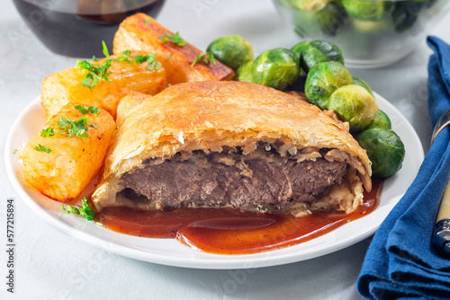Beef Wellington with mushroom Duxelles, served with brussels sprouts and Chateau potato, horizontal