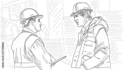 close-up Two male engineers are talking in front of the construction.