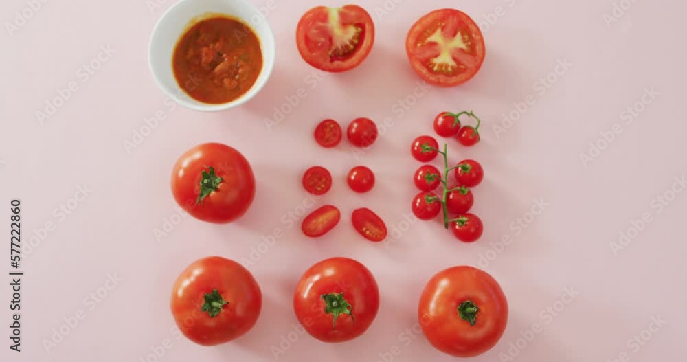 Video of fresh red tomatoes and tomato sauce with copy space on pink background Video of fresh red tomatoes and tomato sauce with copy space on pink background