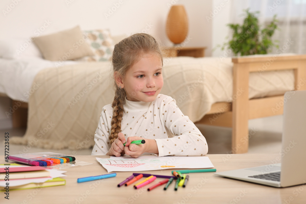 Little girl drawing with felt-tip pen following online course at home. Time for hobby Little girl drawing with felt-tip pen following online course at home. Time for hobby