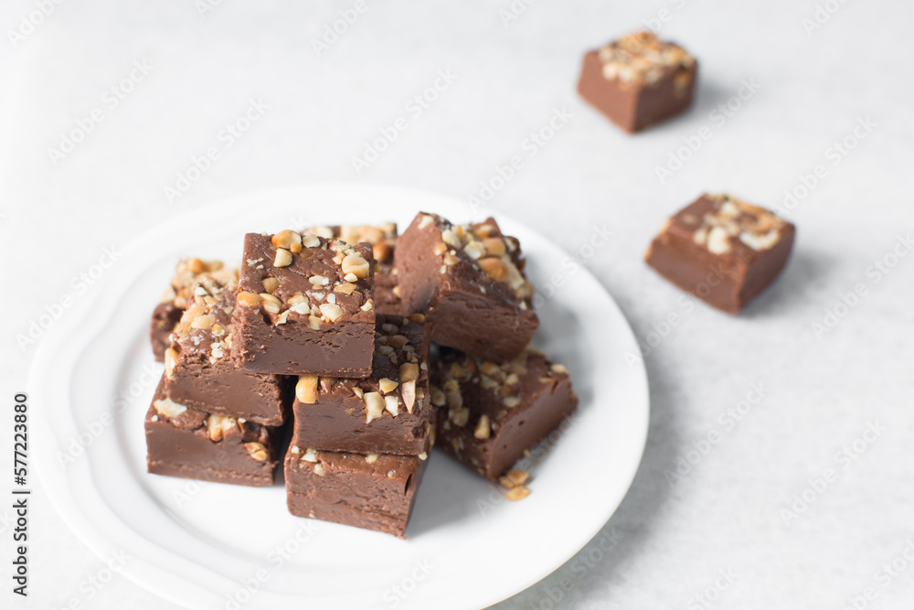 chocolate fudge with nuts on a marble tray, chocolate fudge cut into pieces, fudge candy on a marble tray chocolate fudge with nuts on a marble tray, chocolate fudge cut into pieces, fudge candy on a marble tray
