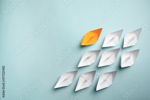 Fotografia Yellow paper boat among others on light background, flat lay with space for text