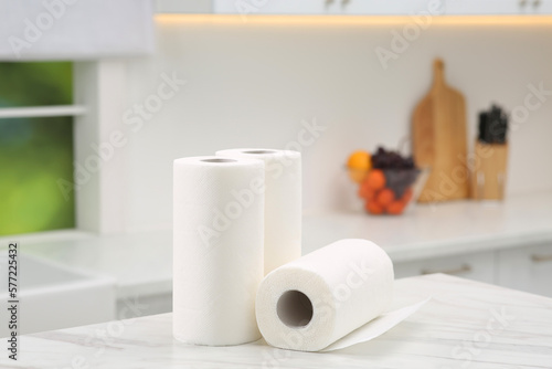 Rolls of paper towels on white marble table in kitchen