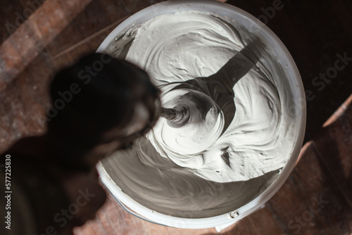 Billede på lærred Plaster compound mixed in a 5 gallon bucket, home renovation theme, construction