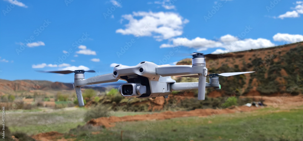 Drone in flight in open field (UAS) Drone in flight in open field (UAS)