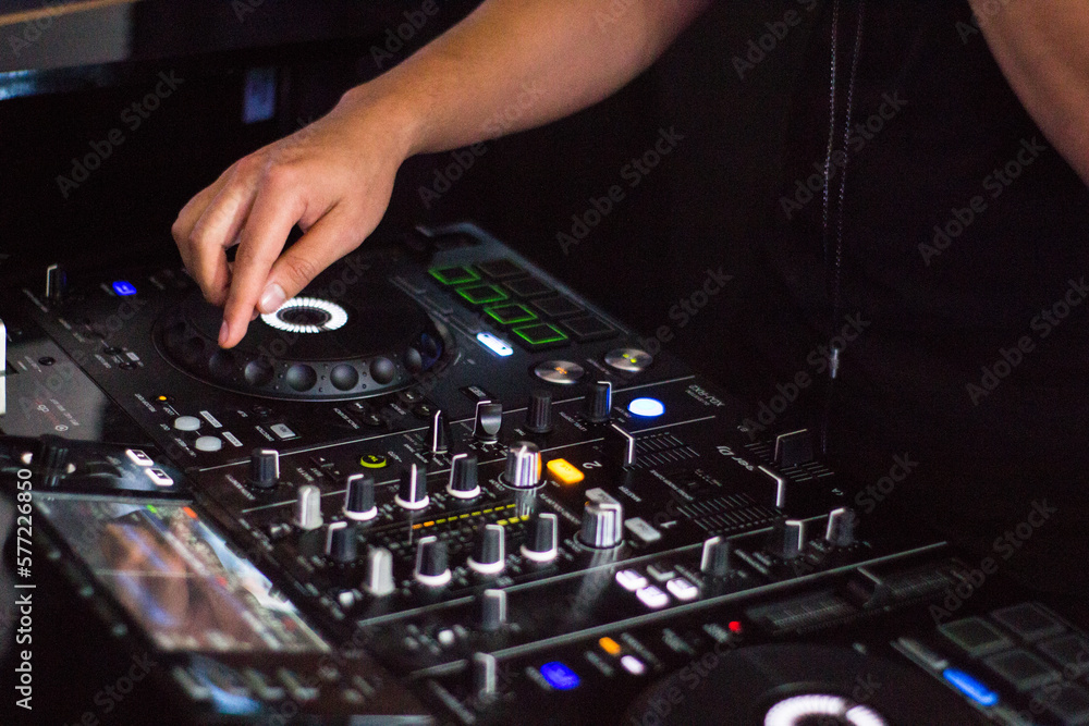 dj hand manipulating the mixing console dj hand manipulating the mixing console