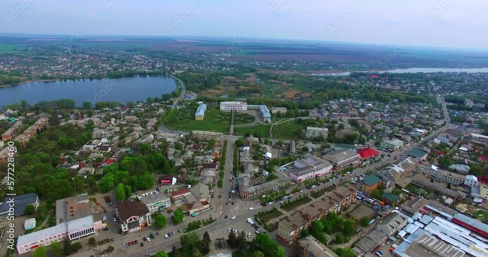 Little provincial city of Ukraine. Small pond and historical palaces in the centre. Agricultural fields at backdrop. Little provincial city of Ukraine. Small pond and historical palaces in the centre. Agricultural fields at backdrop.