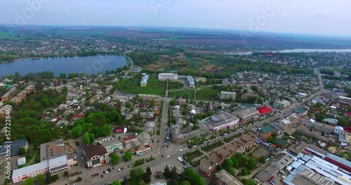 Little provincial city of Ukraine. Small pond and historical palaces in the centre. Agricultural fields at backdrop. photo