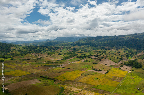 Aerial drone of Agricultural land and mountains with green forest. Philippines.