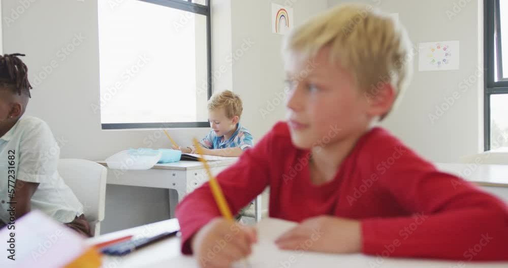 Video of diverse boys sitting at school desks during lessons Video of diverse boys sitting at school desks during lessons