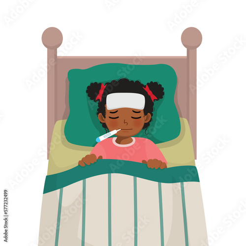 Sick little African girl has high fever flu and cold lying on bed with thermometer in his mouth