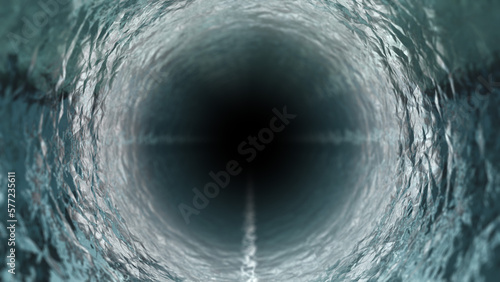 暗闇のなか暗い井戸のようなトンネル状のゴツゴツした筒の中をライトをつけて進む背景 photo