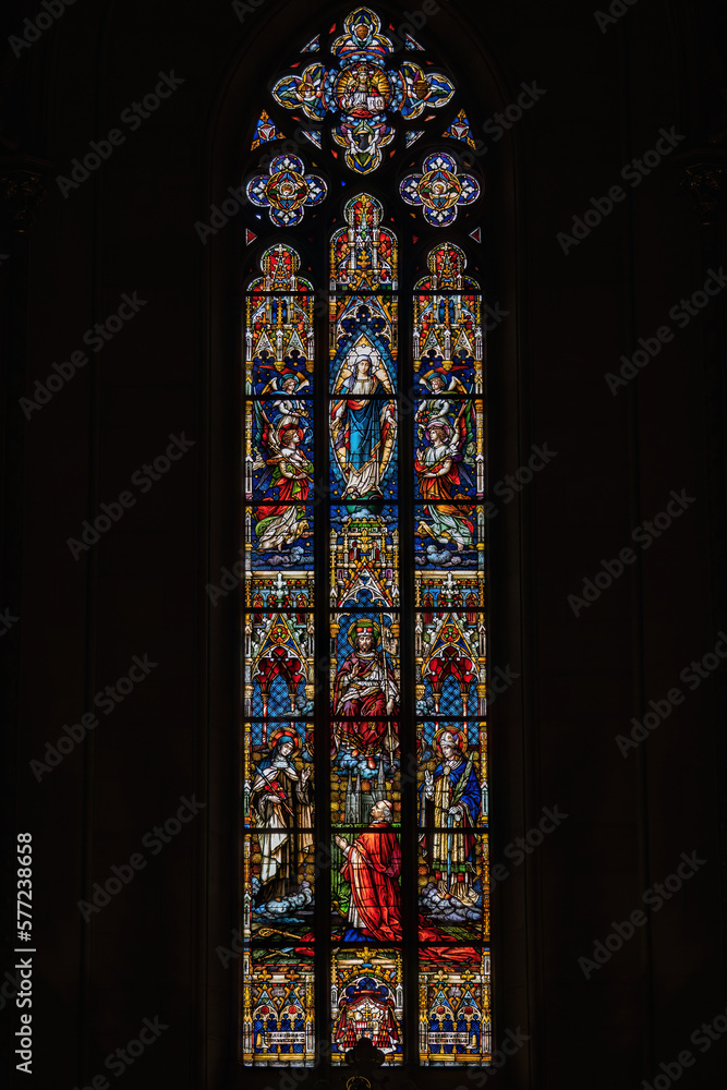 Stained glass in a church window with a Christian theme.