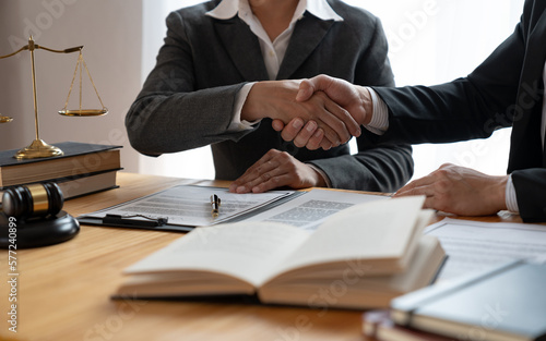 Lawyers shake hands with business people to seal a deal with partner lawyers. or a lawyer discussing contract agreements, handshake concepts, agreements, agreements