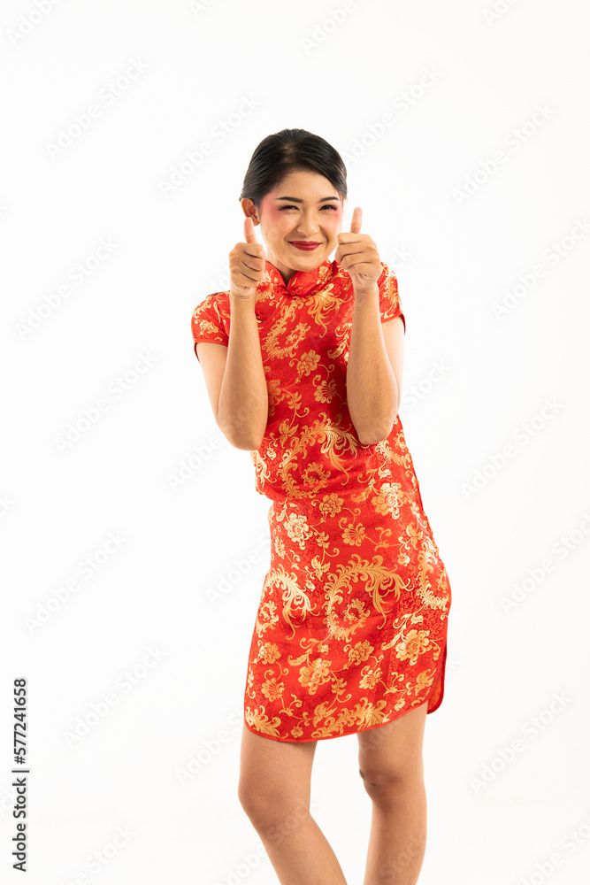 a beautiful asian woman in red cheongsam standing with thumbs up and smiling a beautiful asian woman in red cheongsam standing with thumbs up and smiling