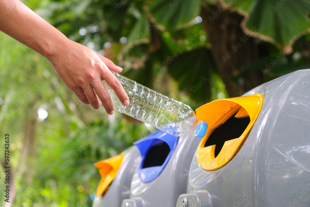 Please throw plastic bottles in the bin. Man littering the bins by