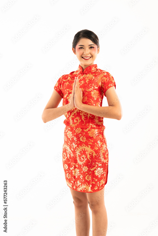 beautiful asian woman in red cheongsam standing put hands together and smiling showing her teeth beautiful asian woman in red cheongsam standing put hands together and smiling showing her teeth