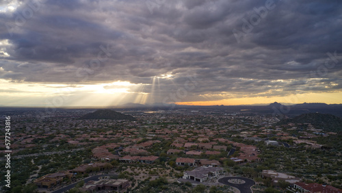 An aerial view of the Mesa Arizona valley with dramatic clouds and sun rays.