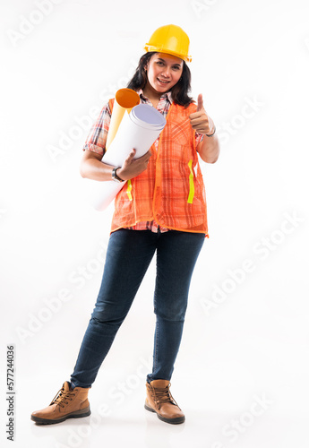 female architect in safety waistcoat standing with thumb up and bring the paperworks on isolated background