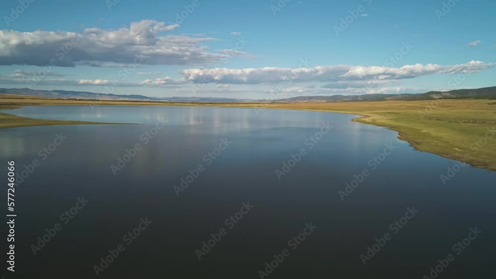 Aerial drone view over sunset lake. Beautiful peaceful sunset lake reflection. Aerial drone view over sunset lake. Beautiful peaceful sunset lake reflection.