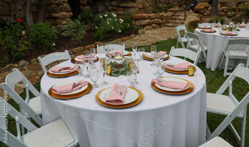 Table setting for garden wedding reception. Event rental equipment concept.
