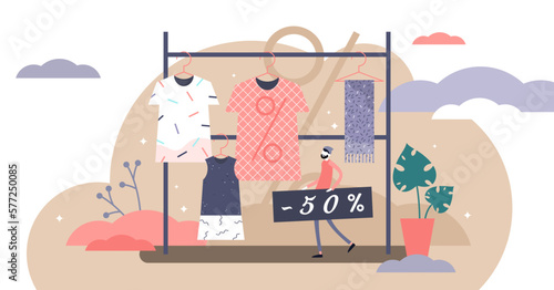 Fashion outlet sale offer concept, flat tiny person illustration, transparent background. Abstract shop interior with trendy style clothes on hangers. Person holding percentage discount sign.