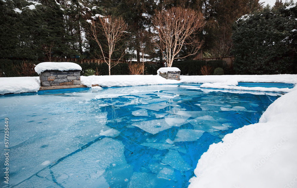 Pool with ice and slush after snow storm. Inground pool with pool cover