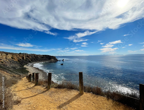 Scenic view of sunny blue sky caostline overlooking the cliffs and ocean from a walking pathway photo