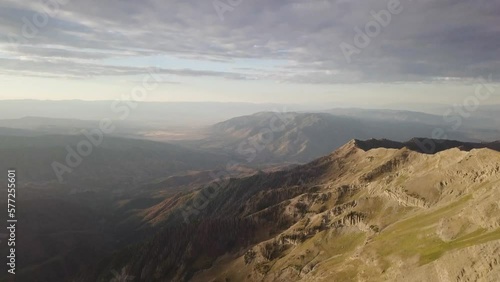 mt nebo salt lake city utah at sunrise sunset on a cloudy day with morning light spilling on the mountain - AERIAL TILT photo