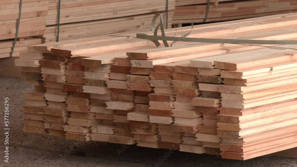 Piles of wooden boards in sawmill. Stock pine wood log in furniture factory. Warehouse for sawing boards for sale, inside a building. Wood timber stack of blanks construction material industry Piles of wooden boards in sawmill. Stock pine wood log in furniture factory. Warehouse for sawing boards for sale, inside a building. Wood timber stack of blanks construction material industry