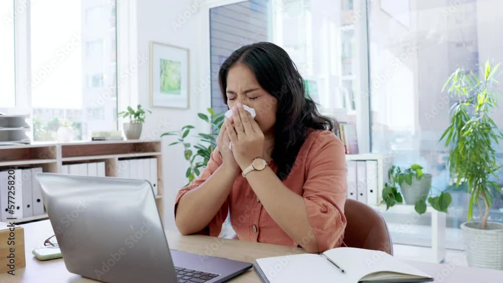Laptop, covid and tissue with a business asian woman blowing her nose while working alone in her office. Computer, sneeze and allergies with a female employee suffering from a cold or flu at work Laptop, covid and tissue with a business asian woman blowing her nose while working alone in her office. Computer, sneeze and allergies with a female employee suffering from a cold or flu at work