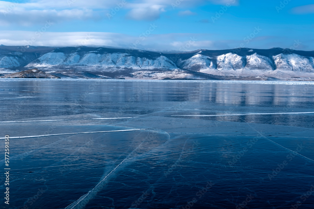 Clean and transparent ice with cracks on Lake Baikal in February, Russia