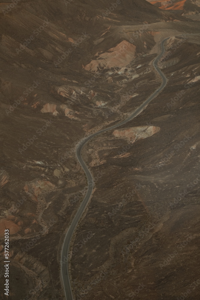 road through the desert hills aerial view