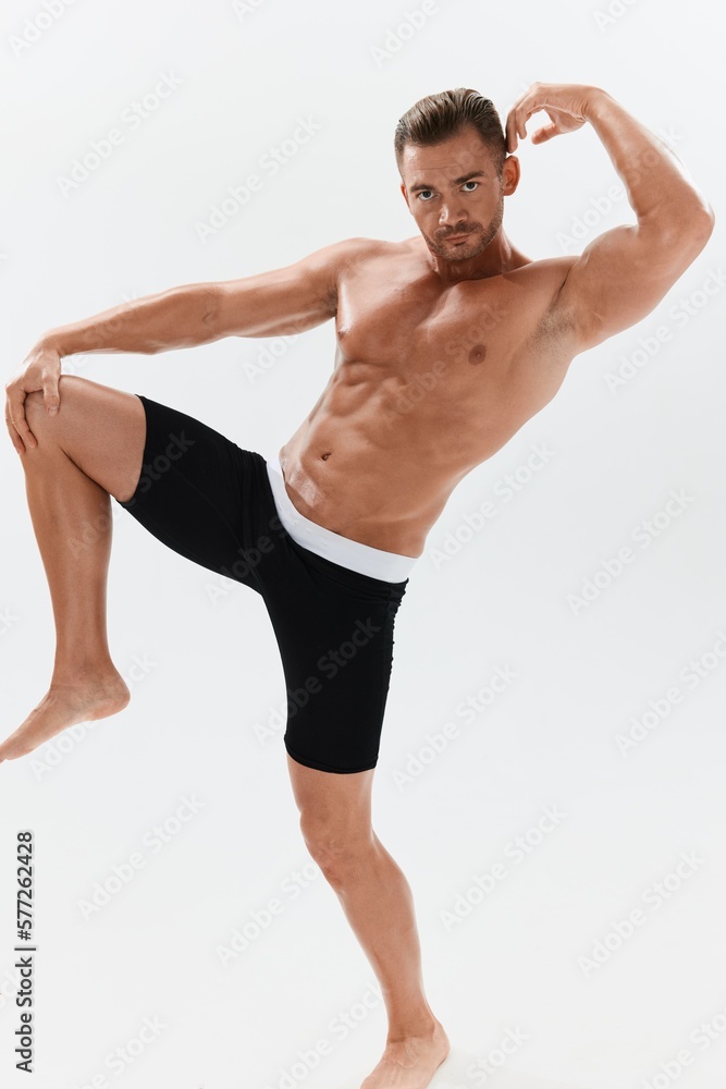 Man athletic body bodybuilder in briefs with naked torso abs full-length in the background, fitness classes. Advertising, sports, active lifestyle, competition, challenge concept. Man athletic body bodybuilder in briefs with naked torso abs full-length in the background, fitness classes. Advertising, sports, active lifestyle, competition, challenge concept.