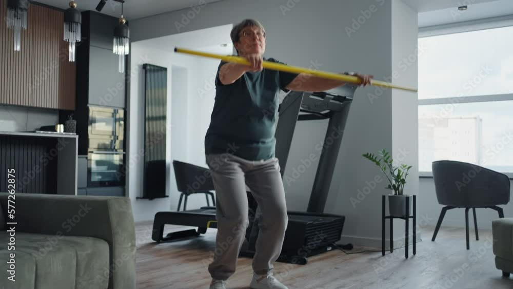 Active Overweight Woman Doing Exercise At Home, Holding Fitness Stick, Squatting, Healthy Lifestyle Active Overweight Woman Doing Exercise At Home, Holding Fitness Stick, Squatting, Healthy Lifestyle
